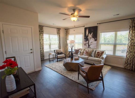 a living room with furniture and a ceiling fan