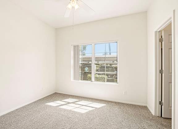 A room with a window and a door.