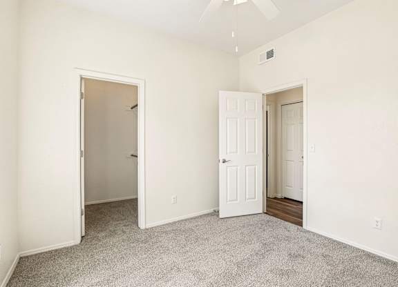 A room with two doors and a carpeted floor.