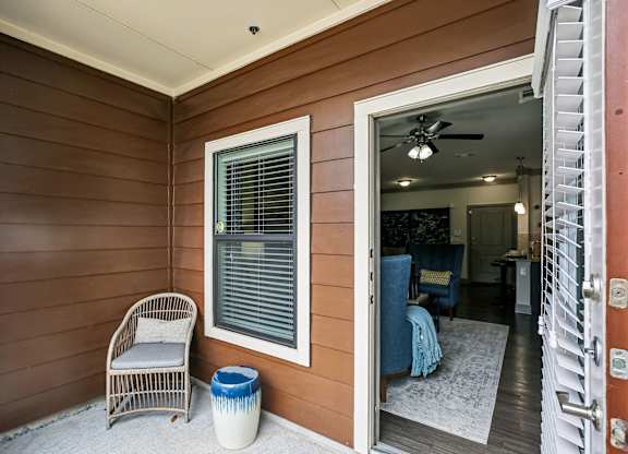 A room with a chair and a table is visible from the doorway.
