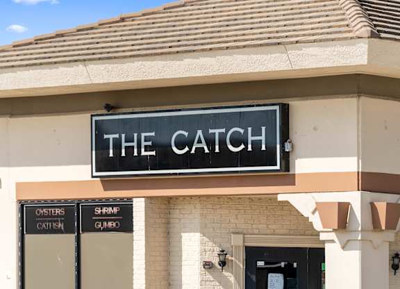 The Catch restaurant sign is displayed on a building.