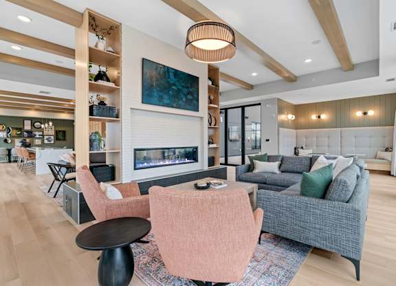 a living room with couches and chairs and a fireplace