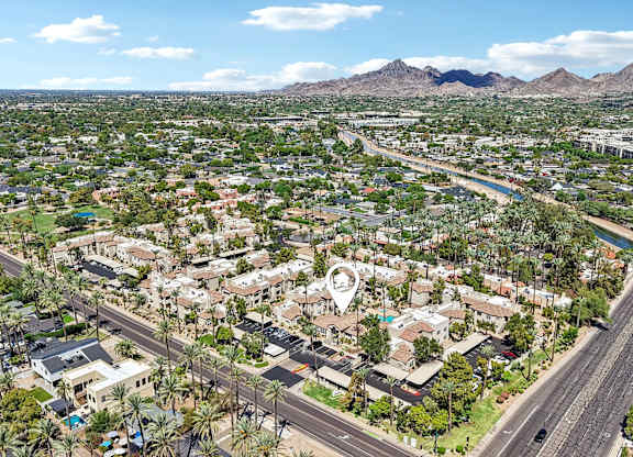 A bird's eye view of a residential area with a road running through it.
