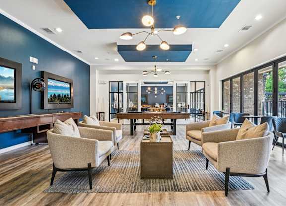 A living room with a blue wall and a wooden floor.