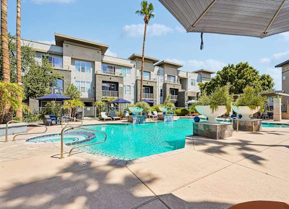 A swimming pool surrounded by apartment buildings.