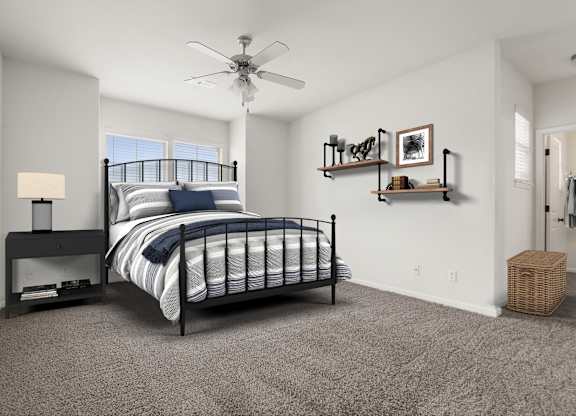 A bedroom with a bed, a fan, and a basket on the floor.
