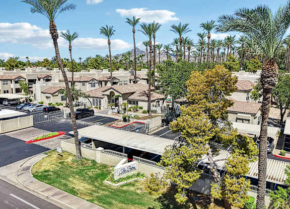 A view of a housing complex with palm trees.