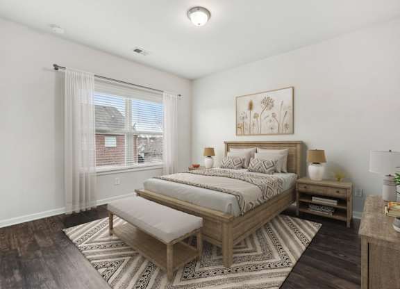 A bedroom with a large bed and a bench in front of it.
