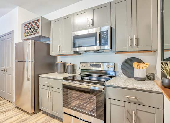 A kitchen with a stainless steel refrigerator and oven.