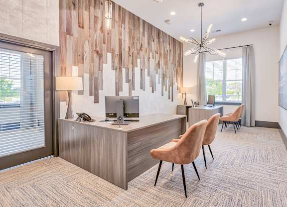 A reception area with a wooden wall panel and two chairs.