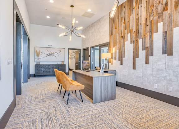 A reception area with a wooden wall panel and a yellow chair.