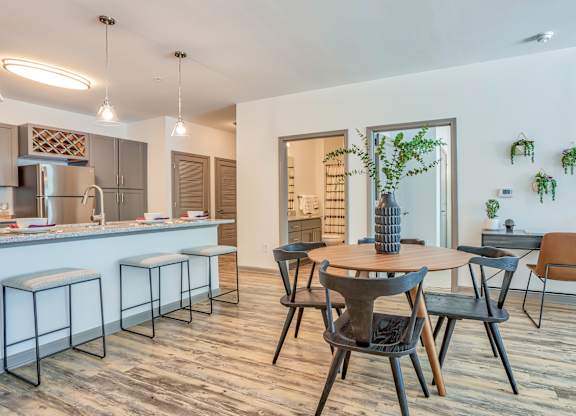 A modern kitchen with a dining table and chairs.