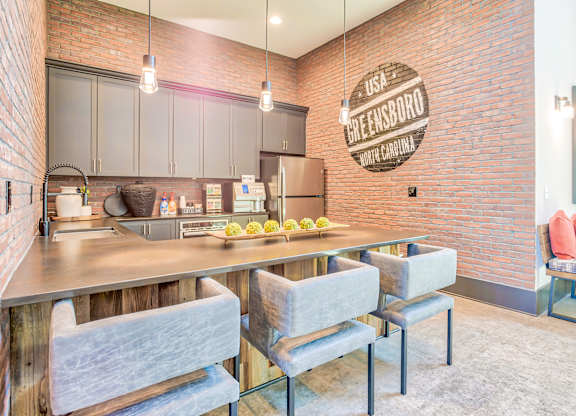 A kitchen with a brick wall and a sign that says