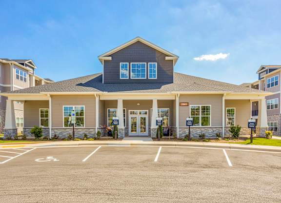 A large building with a parking lot in front of it.