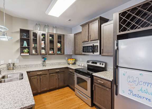 a kitchen with wooden cabinets and granite countertops