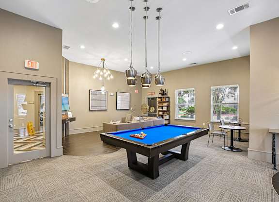 A room with a pool table and a billiard table.