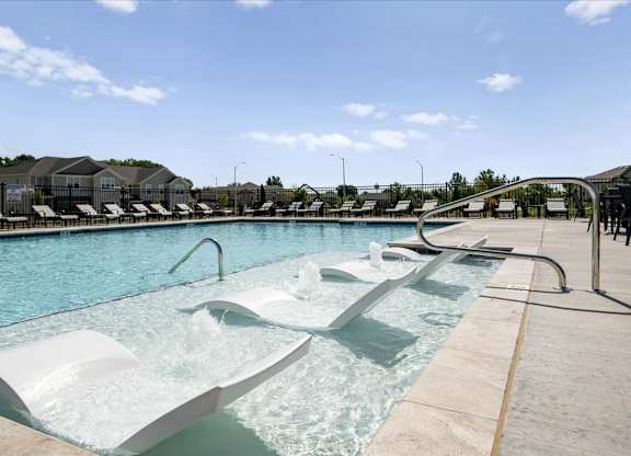 A large outdoor pool with a slide.