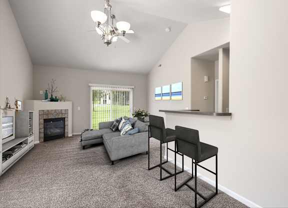 A living room with a grey couch, a fireplace, and a television.