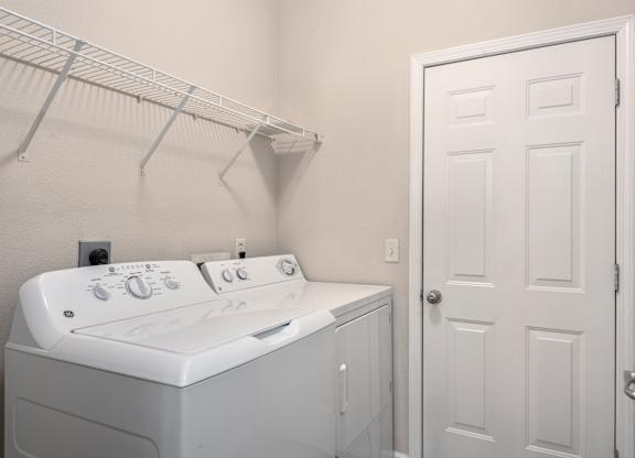 A white washer and dryer in a laundry room.