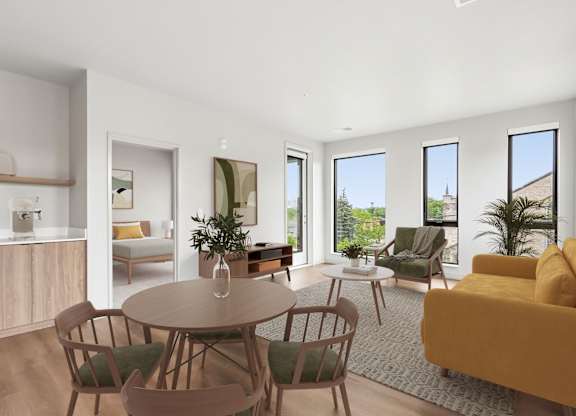 A modern living room with a wooden table and chairs.