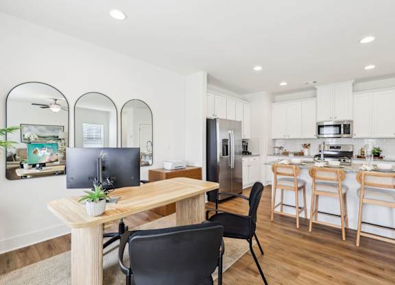A modern kitchen with a dining table and chairs.
