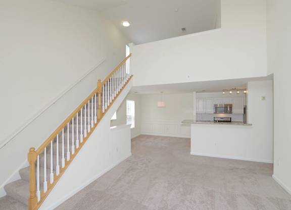 Large open floorplan with a staircase leading to the upper loft