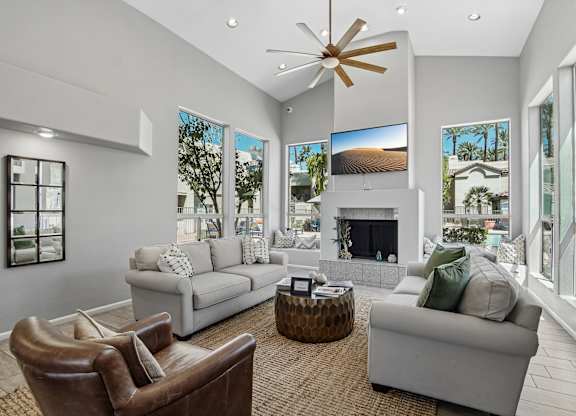 A modern living room with a large window and a fireplace.