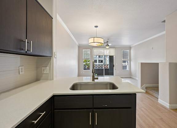 A kitchen with a sink and a counter.