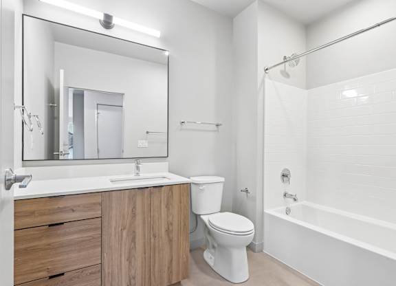 A white bathroom with a sink, toilet, and bathtub.