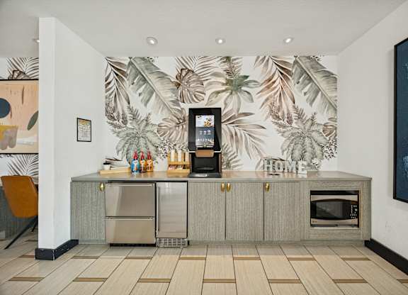 A kitchen with a wallpapered backdrop and a refrigerator with a digital display.