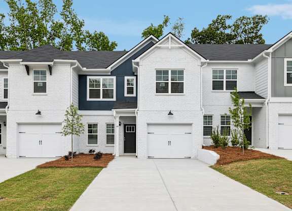 A row of houses with white and blue siding.
