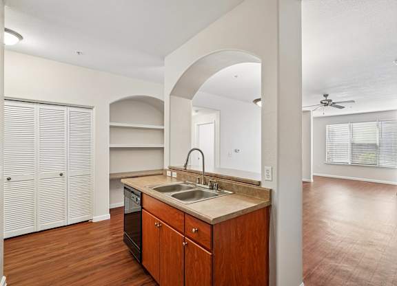 A kitchen with wooden cabinets and a sink.