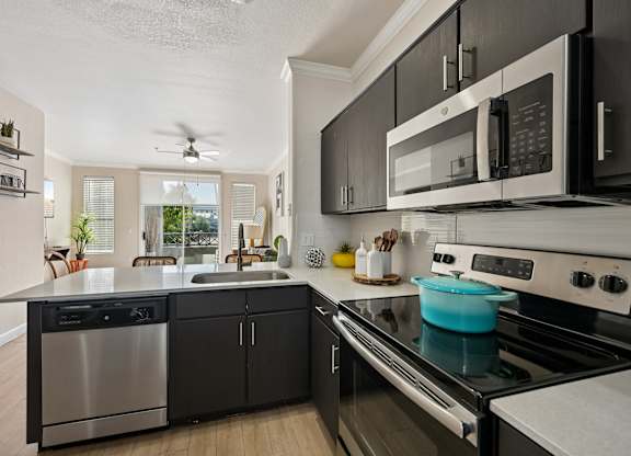 A modern kitchen with a stainless steel dishwasher and oven.