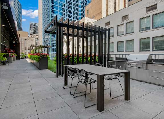 A table and chairs are set up on a patio.