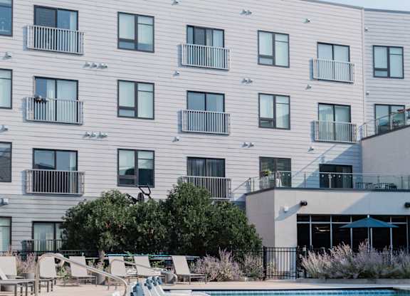 A modern building with a pool in front.