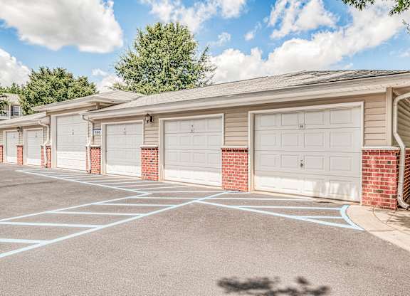 A row of garage doors in front of a building.