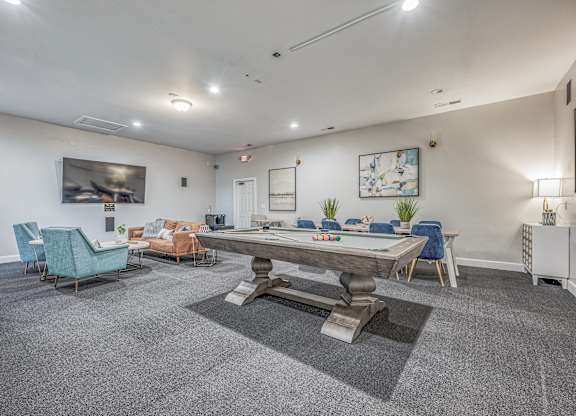 A room with a long table and chairs.