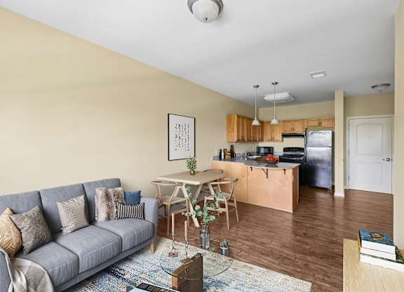 A living room with a grey couch and a wooden table.