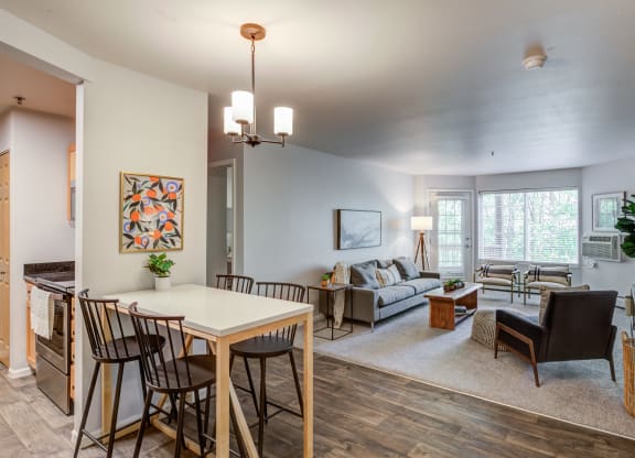 an open living room and dining room with a table and chairs at Birchwood Apartment Homes in Maple Grove, MN