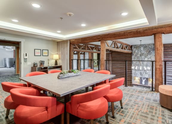 a dining room with a wooden table and chairs at Birchwood Apartment Homes in Maple Grove, MN