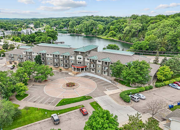 A large building with a circular courtyard in front of it.