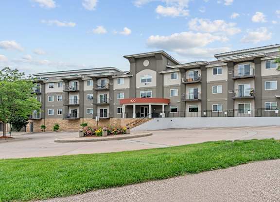 Apartment building with a green lawn in front.