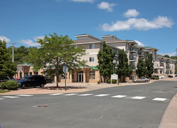 an empty street with a large apartment building on the side of it