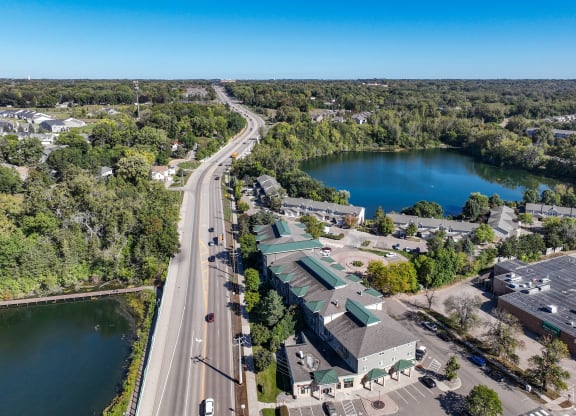an aerial view of a city with a lake and a highway