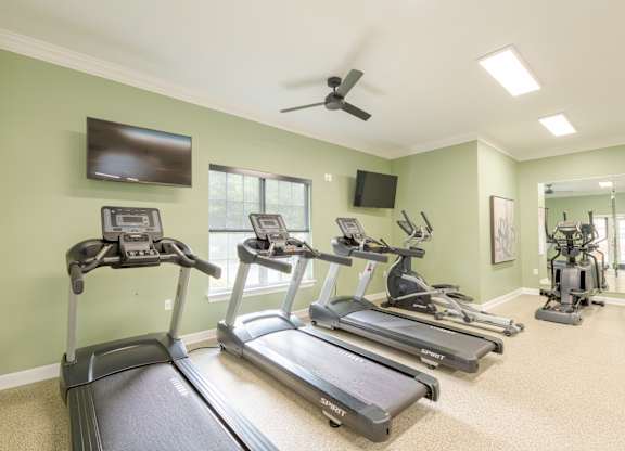 A room with treadmills and exercise equipment.