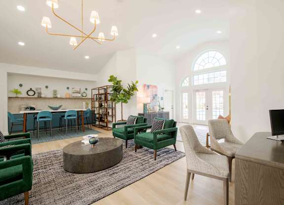 A modern living room with a green sofa and a wooden coffee table.
