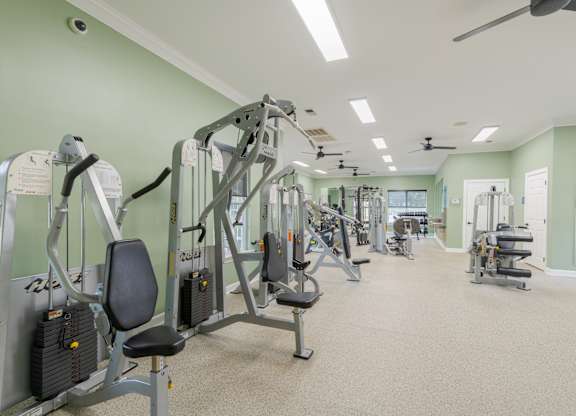 A spacious gym with a variety of equipment.