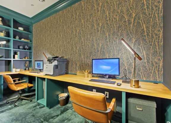 A computer desk with a blue screen monitor and a chair.
