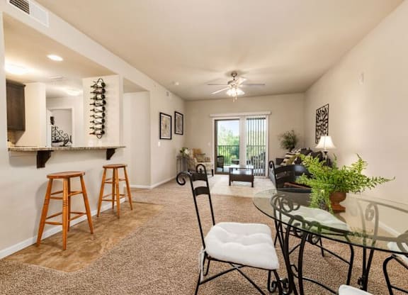 A dining room with a glass table and chairs.
