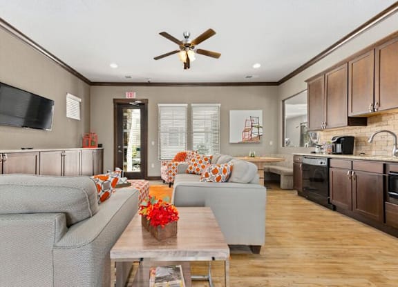 A modern living room with a grey couch and a wooden coffee table.